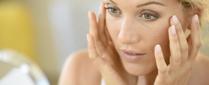 Woman with fingers pressed to her temples