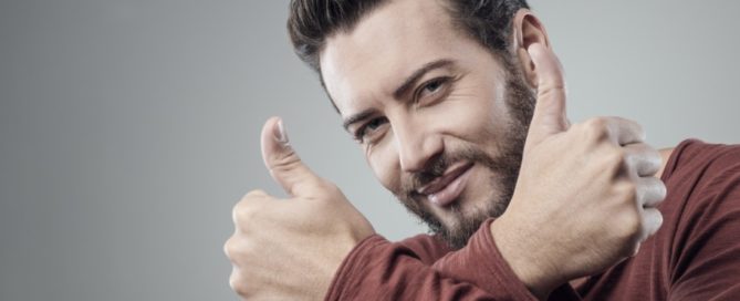 Cool attractive guy thumbs up smiling at camera