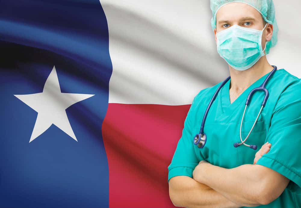 Doctor in front of a flag of Texas