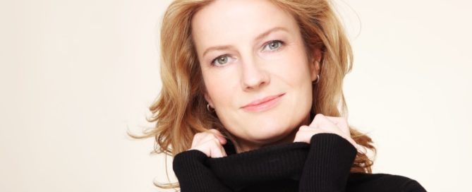 Portrait of beautiful happy smiling mature woman with curly hair and clean make-up