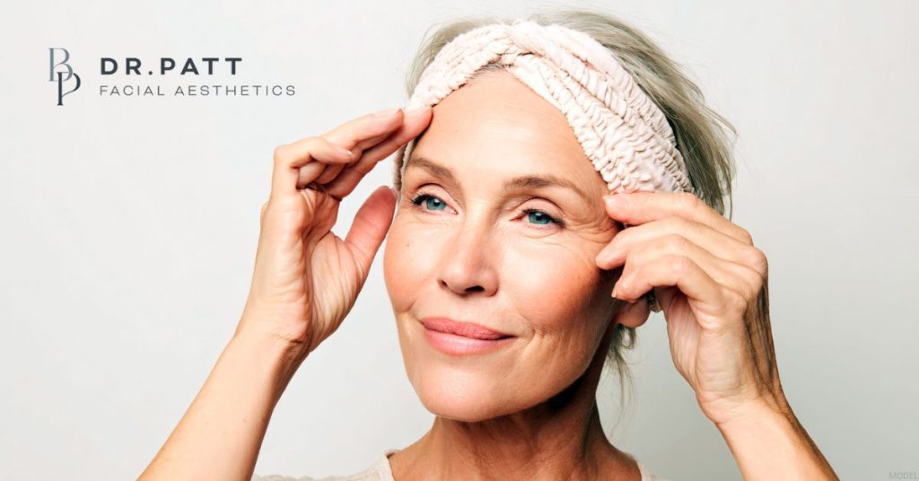 Woman smiling after her ponytail facelift (model)